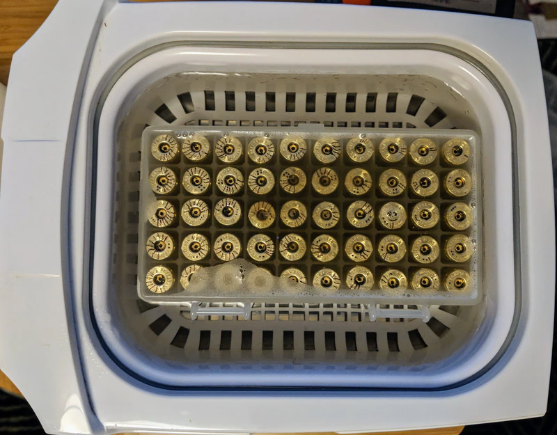 Ultrasonic cleaning brass cases while maintaining the order.